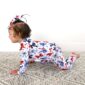 Baby crawling in patriotic jumpsuit and headband