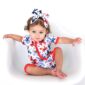 Baby in patriotic outfit with matching headband.