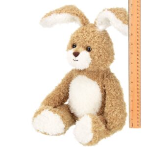 Fuzzy plush bunny with ruler for size reference.
