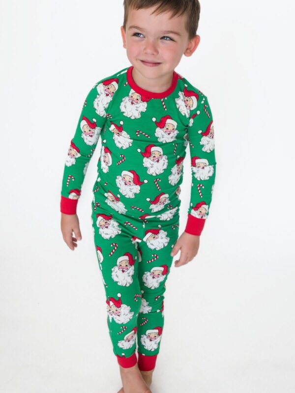 rufflebutts green santa joy long sleeve pajama set Child wearing Santa-themed green pajamas.