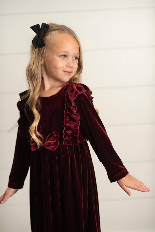 oopsie daisy kids burgundy wine velvet bow ruffle holiday party dress Child in red velvet dress with black bow