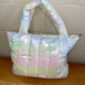 Iridescent puffer tote bag on wooden surface