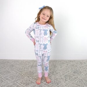 Smiling child in bow-patterned pajamas