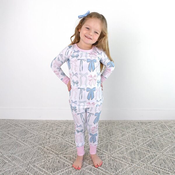 gigi and max samantha bows two piece no button bamboo kids lounge Smiling child in bow-patterned pajamas