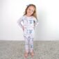 Smiling child in bow-patterned pajamas