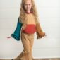 Child modeling colorful outfit with ruffle details
