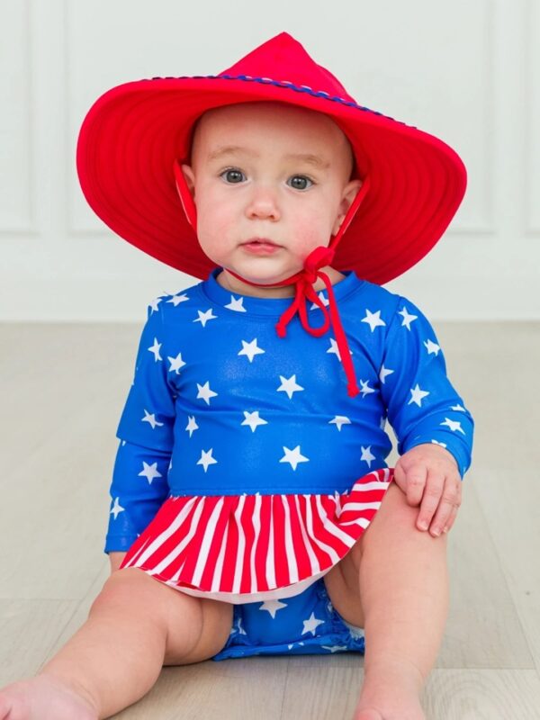 Baby in patriotic outfit with red hat