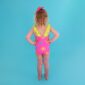Child in colorful swimsuit on blue background