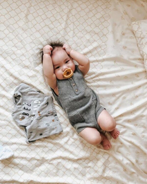 itzy ritzy sweetie soother™ pacifier sets (2 pack): agave + succulent cables Baby lying on bed with pacifier