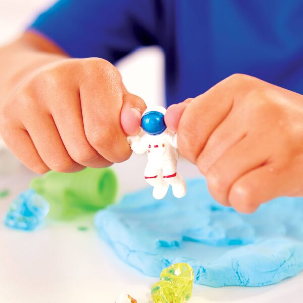 faber castell / creativity for kids sensory pack outer space on the go play set for kids Child holding toy astronaut with blue playdough.