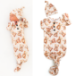 Baby in teddy bear outfit with matching hat.