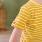 Child in yellow striped shirt, partial view