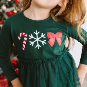 Child wearing festive holiday dress with symbols