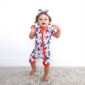 Child in colorful romper and matching headband