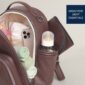 Brown diaper bag with baby essentials inside.