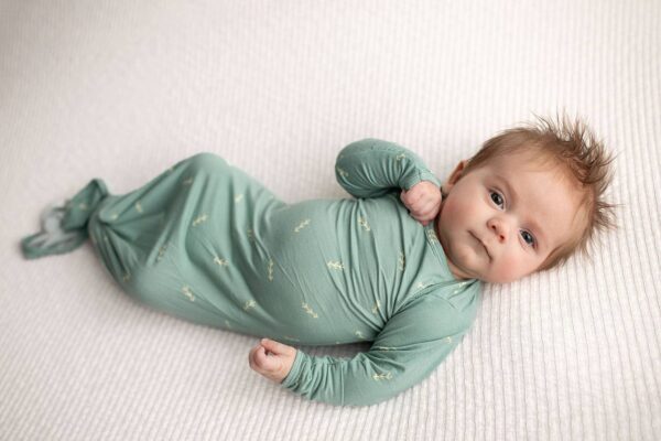 three little tots arrow print knotted newborn baby gown pajamas Baby in green swaddle on white blanket