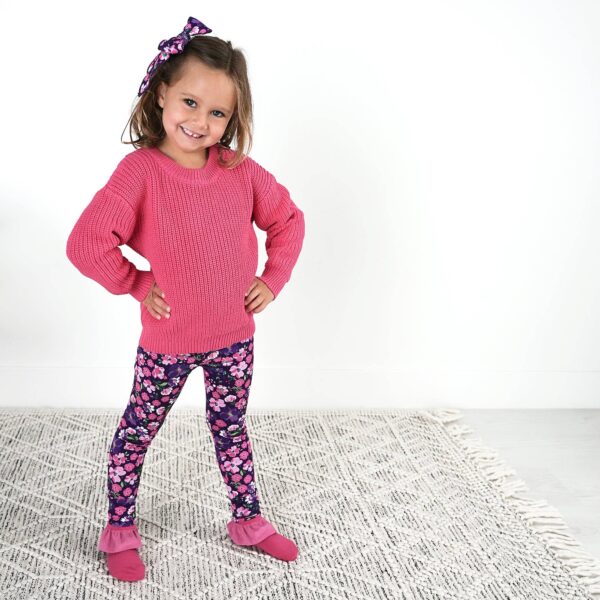 gigi and max mila leggings and sweater set Child in pink sweater and floral leggings smiling.