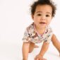 Cute baby crawling in floral outfit