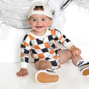 Baby in Halloween-themed outfit smiling