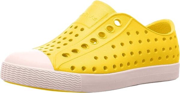 Yellow perforated casual shoe with white sole.