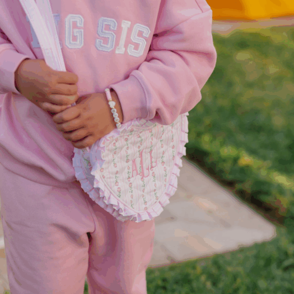 bits & bows floral quilted heart purse Child in pink outfit holding a frilly bag