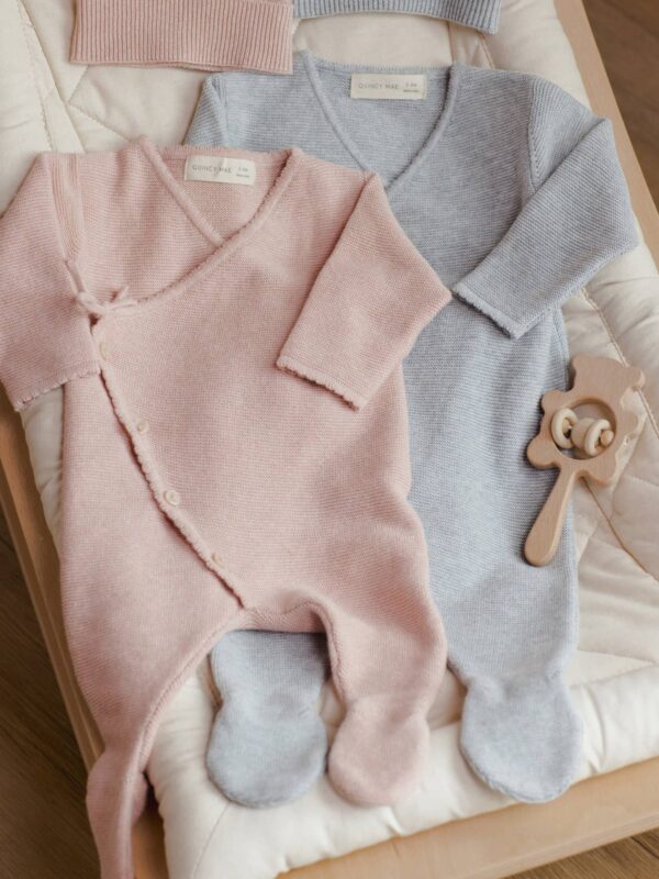 quincy mae wrap knit footie heathered rose with matching hat Pink and blue baby onesies with rattle.