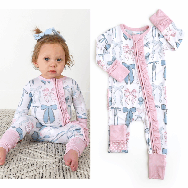 gigi and max samantha bows ruffle zip bamboo sleeplies little outfit Baby wearing bow-patterned romper on patterned rug.