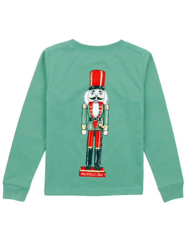 Green shirt with nutcracker design.