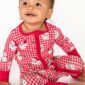 Smiling baby in red checkered pajamas.
