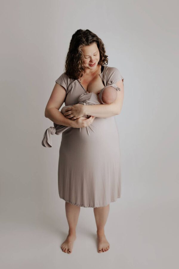 three little tots harbor mist taupe knotted gown Mother holding newborn in neutral outfit.