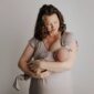 Mother lovingly holding newborn baby.