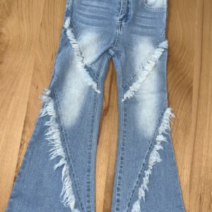 Blue flared jeans with frayed seams on floor
