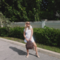 Woman in sunglasses with backpack on sunny day.