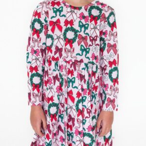 Child wearing festive bow-print dress