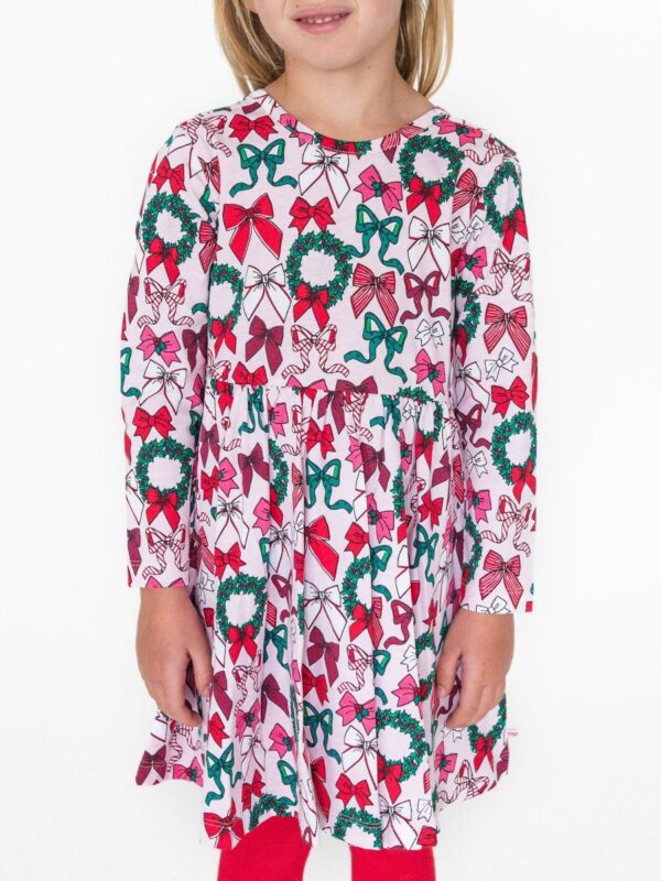 Child wearing festive bow-print dress