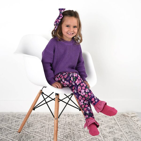 gigi and max mila leggings and sweater set Girl in purple sweater and floral leggings sitting