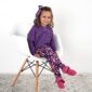 Girl in purple sweater and floral leggings sitting