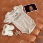 Organic baby onesie with socks and pacifier.
