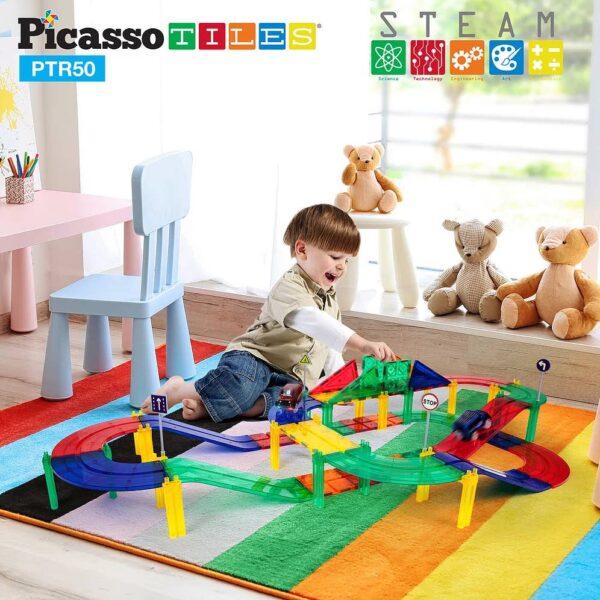 picassotiles 50 piece racetrack Child playing with colorful toy tracks on carpet.