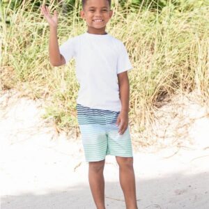 Smiling boy waving on a sunny beach day.