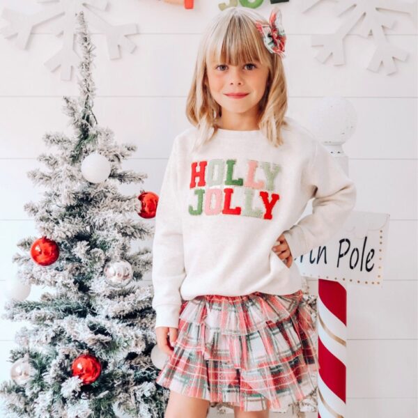 sweet wink christmas plaid tutu Child in festive outfit by decorated Christmas tree.