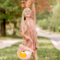 Girl tossing leaves in autumn park