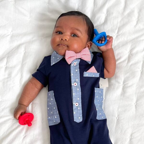 itzy ritzy sweetie soother™ pacifier sets (2 pack): agave + succulent cables Baby in formal outfit with bow tie and pacifier.