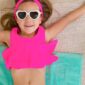 Girl in pink swimsuit and heart-shaped sunglasses