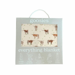 Cow-patterned blanket packaging with multi-use icons.