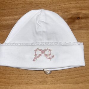 White baby hat with pink floral embroidery
