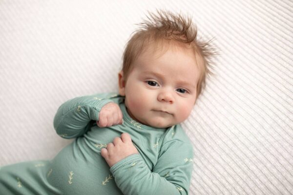 three little tots arrow print knotted newborn baby gown pajamas Cute baby in green onesie on blanket