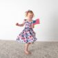 Child in dress holding American flag