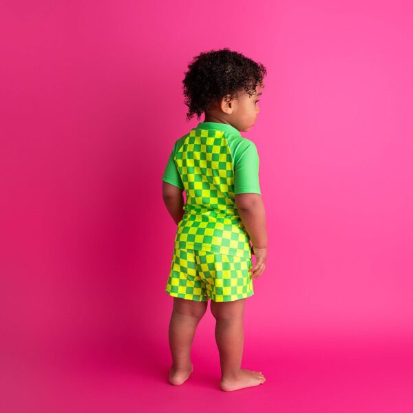 gigi and max brad green neon swim set Child in checkered outfit on pink background