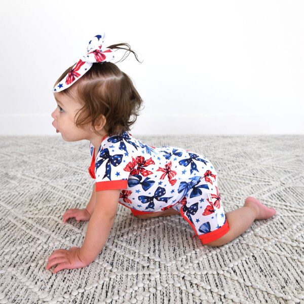 gigi and max eleanor bow clip bow 4th of july hair accessory Baby in patriotic outfit crawling on carpet.